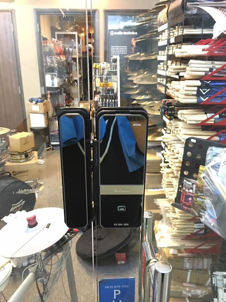 Assa Abloy Shine digital lock for glass swing door at a music shop